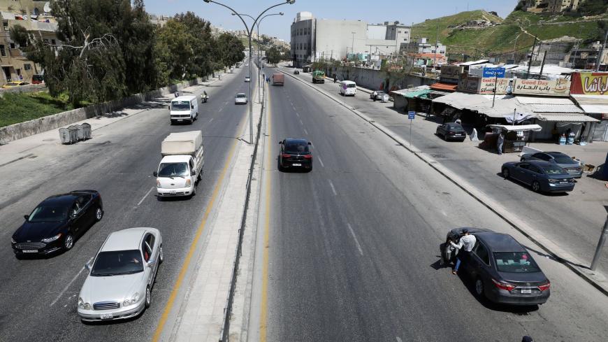 Jordanian police check the electronic passes, amid concerns over the spread of the coronavirus disease (COVID-19), at a checkpoint in Amman, Jordan April 8, 2020. REUTERS/Muhammad Hamed - RC2D0G93LSTB
