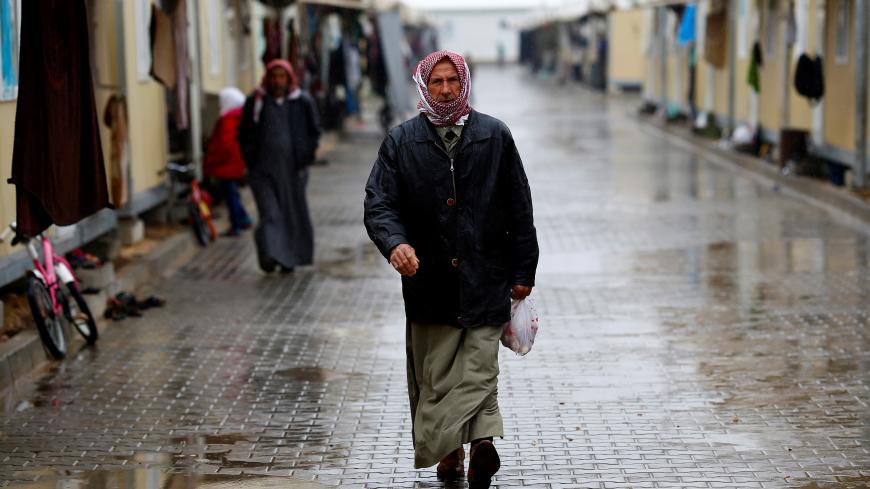 A Syrian refugee man walks in Elbeyli refugee camp near the Turkish-Syrian border in Kilis province, Turkey, December 1, 2016. REUTERS/Umit Bektas - RC118F65CE00