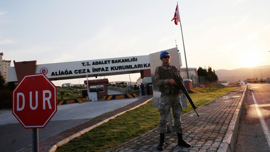 A Turkish police special forces officer stands guard in front of the Aliaga Prison and Courthouse complex in Izmir, Turkey October 12, 2018. REUTERS/Umit Bektas - RC1DC5DD0C60