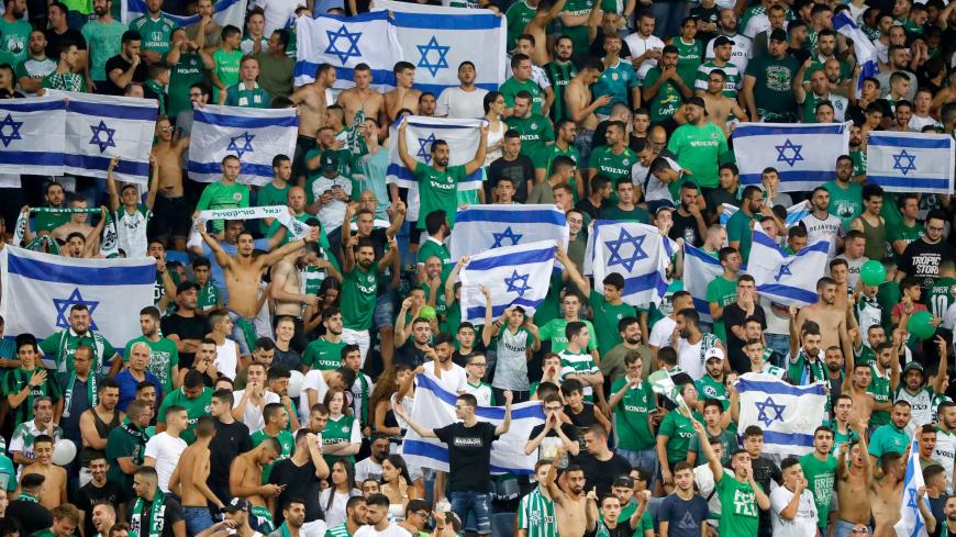 Maccabi fans cheer for their team prior to the second leg of the Europa league second round qualifier football match between Maccabi Haifa and RC Strasbourg at the Sammy Hofer stadium in Haifa on August 1, 2019. (Photo by Jack GUEZ / AFP)        (Photo credit should read JACK GUEZ/AFP via Getty Images)