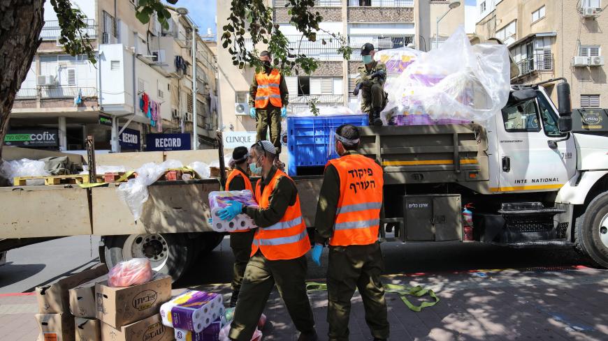 BNEI BRAK, ISRAEL -APRIL 7: Israeli soldiers distribute food and basic necessities to people within precautions against coronavirus (Covid-19) pandemic in Bnei Brak, Israel on April 7, 2020. (Photo by Mostafa Alkharouf/Anadolu Agency via Getty Images)