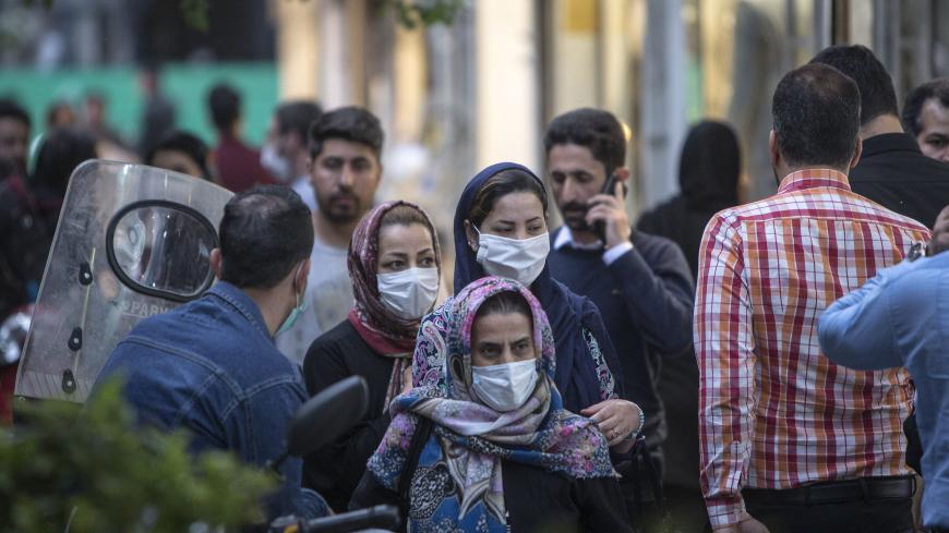 TEHRAN, April 30, 2020 .People wearing face masks walk on a street in downtown Tehran, Iran, on April 29, 2020. Iran's Health Ministry on Wednesday reported 1,073 new COVID-19 cases, bringing the total number of infections to 93,657, state TV reported. (Photo by Ahmad Halabisaz/Xinhua via Getty)