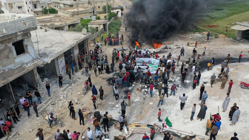 A drone images shows Syrian demonstrators gathering during a protest in the village of Maaret al-Naasan in Syria's Idlib province on May 1, 2020, to protests against a reported attack by Hayat Tahrir al-Sham, an alliance led by a former Al-Qaeda affiliate, on a protest the previous day. (Photo by Omar HAJ KADOUR / AFP) (Photo by OMAR HAJ KADOUR/AFP via Getty Images)