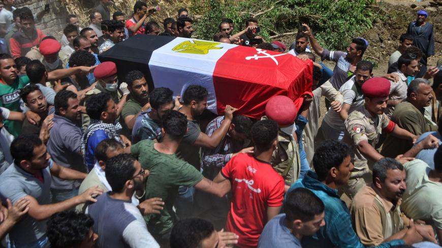 Mourners carry the coffin of Alaa Emad, an Egyptian soldier who was killed in an explosion targeting an armoured vehicle near Bir al-Abed in North Sinai, during his funeral in the vilage of Abwan in the Minya province on May 1, 2020. - Egypt's army said Thursday that 10 soldiers, including an officer, were killed or wounded in an explosion that day targeting an armoured vehicle near Bir al-Abed in North Sinai. The Egyptian army killed two suspected jihadists Friday in restive North Sinai, a day after a blas