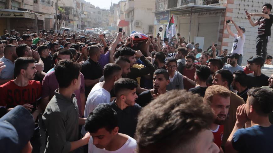 HEBRON, WEST BANK - MAY 13: Palestinians carry the coffin of 15 years old Palestinian Zaid Fadl Qaisia, who was shot in the head by an Israeli soldier in a raid to Al-Fawar refugee camp, during his funeral ceremony in Hebron, West Bank on May 13, 2020. (Photo by Mamoun Wazwaz/Anadolu Agency via Getty Images)