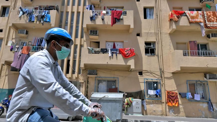 Residents hang their laundry off the railing on their balconies at their apartment building, to disinfect them under sunlight, in the city of Dubai on May 17, 2020, during the spread of the COVID-19 pandemic. (Photo by Karim SAHIB / AFP) (Photo by KARIM SAHIB/AFP via Getty Images)