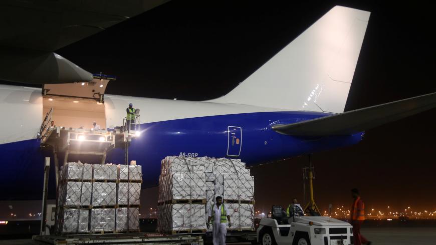 Workers load aid onto an airplane to be delivered to Rohingya refugees residing in Bangladesh, in coordination between UNHCR and United Arab Emirates, at Dubai airport, UAE, October 11, 2017. REUTERS/Satish Kumar - RC1C12FE9CB0