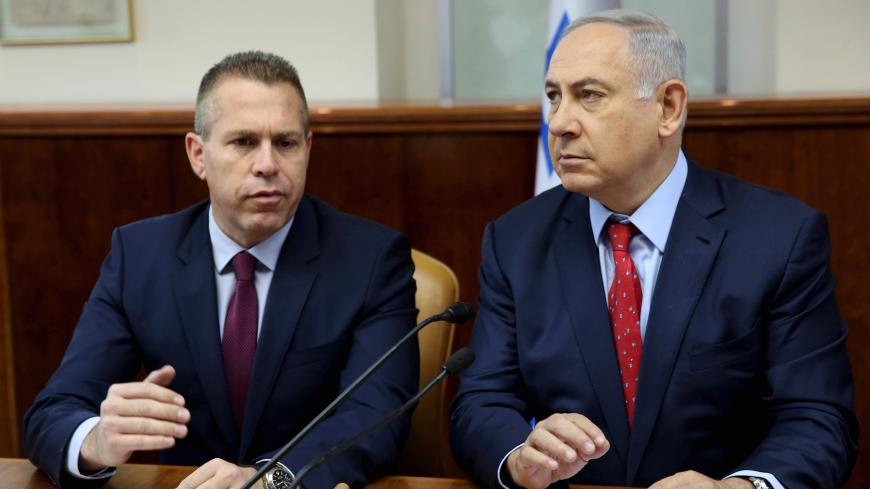 FILE PHOTO: Israeli Prime Minister Benjamin Netanyahu (R) sits next to Israeli Public security Minister Gilad Erdan during the weekly cabinet meeting in Jerusalem April 10, 2016. REUTERS/Gali Tibbon/Pool/File photo - RC17175E03C0