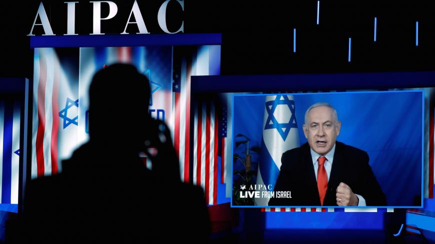 Speaking via satellite feed from Israel, Israeli Prime Minister Benjamin Netanyahu addresses AIPAC  in Washington, U.S., March 26, 2019. REUTERS/Kevin Lamarque - RC1F1B026080