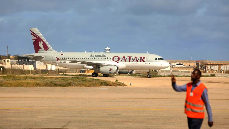 REFILE - CORRECTING NAME OF AIRLINES   A Somali aviation worker prepares to receive a aQatar Airways Airbus A320-200 plane as it makes its maiden arrival at the Aden Abdulle International Airport in Mogadishu, Somalia July 1, 2019. REUTERS/Feisal Omar - RC1CD1A570E0