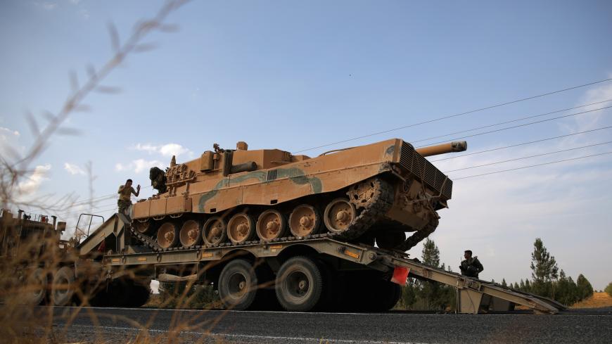 Turkish army tank is being unloaded on a road near the Turkish border town of Ceylanpinar, Sanliurfa province, Turkey, October 18, 2019. REUTERS/Stoyan Nenov - RC13BD854EE0