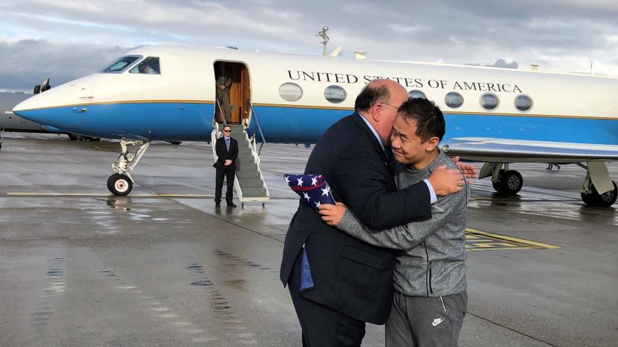 U.S. Ambassador to Switzerland Edward McMullen greets Xiyue Wang in Zurich, Switzerland December 7, 2019. U.S. Embassy in Switzerland/Handout via REUTERS ATTENTION EDITORS - THIS IMAGE WAS PROVIDED BY A THIRD PARTY - RC2GQD9FJJ4H
