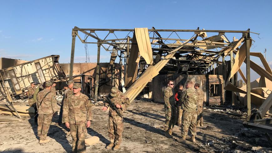 U.S. soldiers inspect the site where an Iranian missile hit at Ain al-Asad air base in Anbar province, Iraq January 13, 2020. REUTERS/John Davison - RC23FE9EJI5L