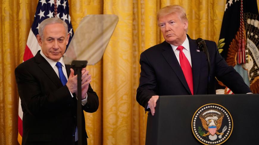 Israel's Prime Minister Benjamin Netanyahu applauds as he and U.S. President Donald Trump deliver joint remarks on a Middle East peace plan proposal in the East Room of the White House in Washington, U.S., January 28, 2020. REUTERS/Joshua Roberts? - RC26PE9IWG1Q
