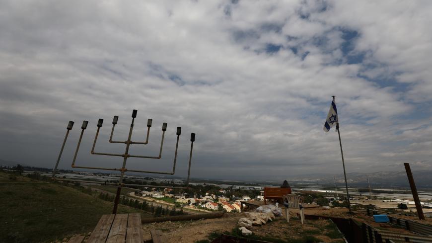 An Israeli flag flies in the Jordan Valley in the Israeli-occupied West Bank February 11, 2020. REUTERS/Ammar Awad - RC2CYE95XEM1