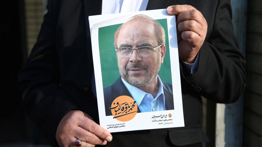 A man holds a poster of Mohammad Baqer Qalibaf one of parliamentary candidate in Tehran, Iran February 18, 2020. Picture taken February 18, 2020, Nazanin Tabatabaee/WANA (West Asia News Agency) via REUTERS ATTENTION EDITORS - THIS IMAGE HAS BEEN SUPPLIED BY A THIRD PARTY. - RC2Q3F9OA8S5