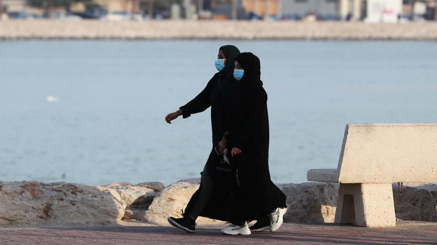 Women wear protective face masks, as they walk, after Saudi Arabia imposed a temporary lockdown on the province of Qatif, following the spread of coronavirus, in Qatif, Saudi Arabia March 10, 2020. REUTERS/Stringer - RC25HF9S55OY