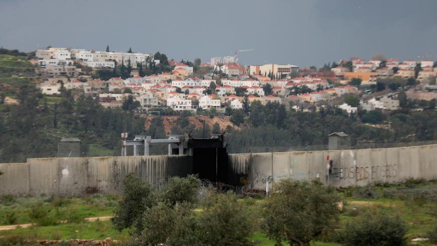 A view shows the Jewish settlement of Modiin Illit in the background and the Israeli barrier in the foreground in the village of Bilin, where a Friday anti-Israel weekly protest is held, as the area is seen empty of Palestinian demonstrators amid concerns of the spread of the coronavirus disease, in the Israeli-occupied West Bank March 20, 2020. REUTERS/Mohamad Torokman - RC2PNF9HQOZQ