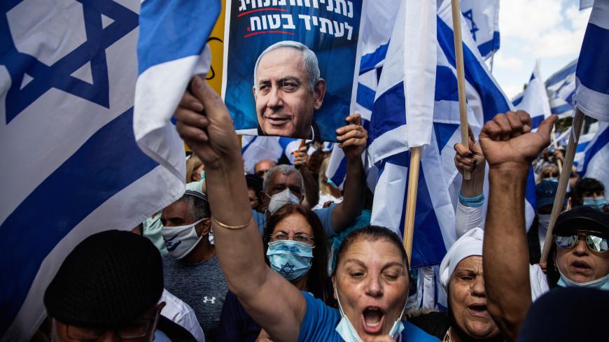 Supporters of Israeli Prime Minister Benjamin Netanyahu take part in a protest outside the Prime Minister's Residence, on the day when Netanyahu's corruption trial starts, in Jerusalem May 24, 2020. Heidi levine/Pool via REUTERS - RC23VG9JYPOZ