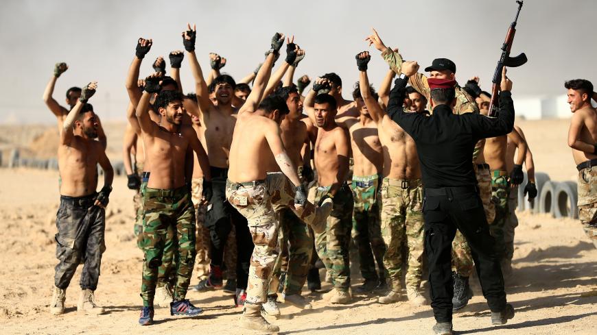 Sunni volunteers, who have joined the Abbas Fighting Division, shout slogans after a field training in Kerbala, Iraq December 20, 2017. Picture taken December 20, 2017. REUTERS/Thaier Al-Sudani - RC116223B030