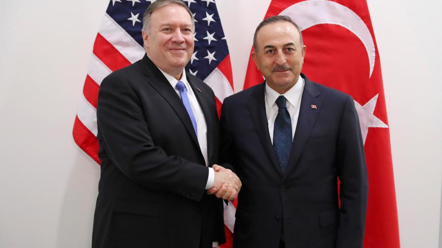 U.S. Secretary of State Mike Pompeo poses with Turkish Foreign Minister Mevlut Cavusoglu during a NATO foreign ministers meeting at the Alliance headquarters in Brussels, Belgium November 20, 2019. Francisco Seco/Pool via REUTERS - RC22FD9VMKIP
