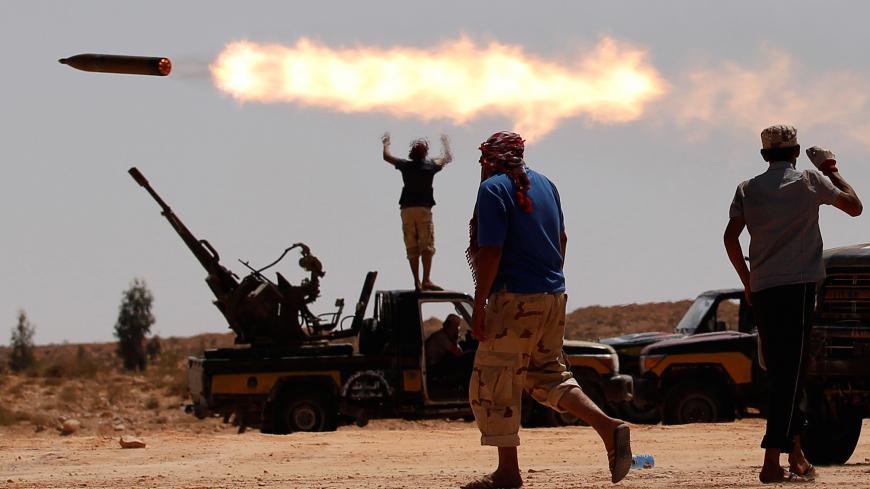 Anti-Gaddafi fighters fire a multiple rocket launcher near Sirte, previously one of Muammar Gaddafi's last remaining strongholds in Libya, September 24, 2011. Picture taken September 24, 2011. REUTERS/Goran Tomasevic/File Photo  SEARCH "POY DECADE" FOR THIS STORY. SEARCH "REUTERS POY" FOR ALL BEST OF 2019 PACKAGES. TPX IMAGES OF THE DAY. - RC2SND9VGEDW