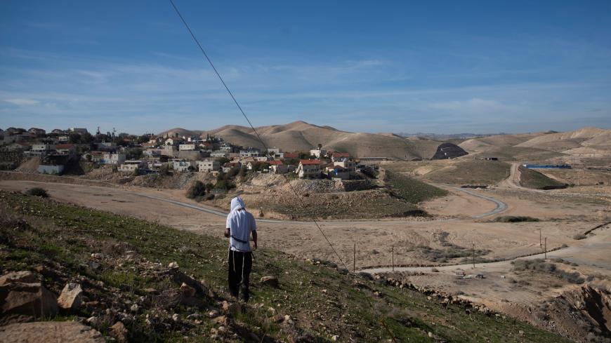 A Jewish shepherd wears a prayer shawl as he stands near houses in the Israeli settlement of Mitzpe Yericho in the Jordan Valley in the Israeli-occupied West Bank January 27, 2020. REUTERS/Ronen Zvulun - RC2COE9DADQT