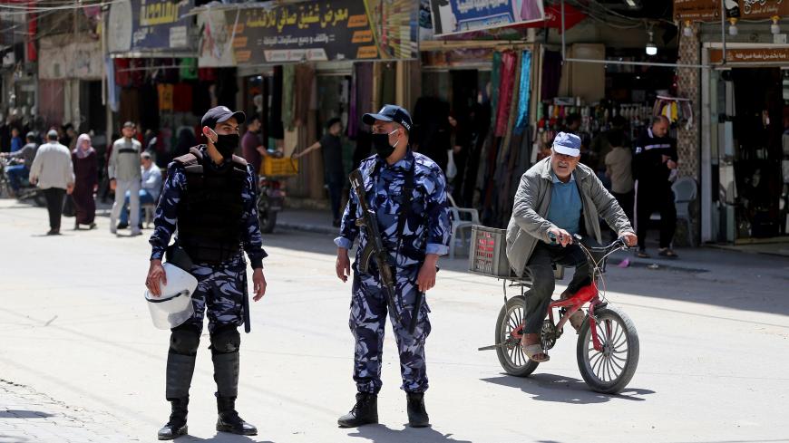 Palestinian policemen loyal to Hamas stand guard in a street amid concerns about the spread of the coronavirus disease (COVID-19), in the southern Gaza Strip April 23, 2020. REUTERS/Ibraheem Abu Mustafa - RC2AAG9OPDHM