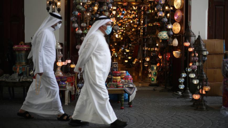 People wear protective face masks following the outbreak of the coronavirus disease (COVID-19), as they walk to shop ahead of the holy month of Ramadan in Manama, Bahrain, April 23, 2020. REUTERS/Hamad I Mohammed - RC2CAG9GB8NR