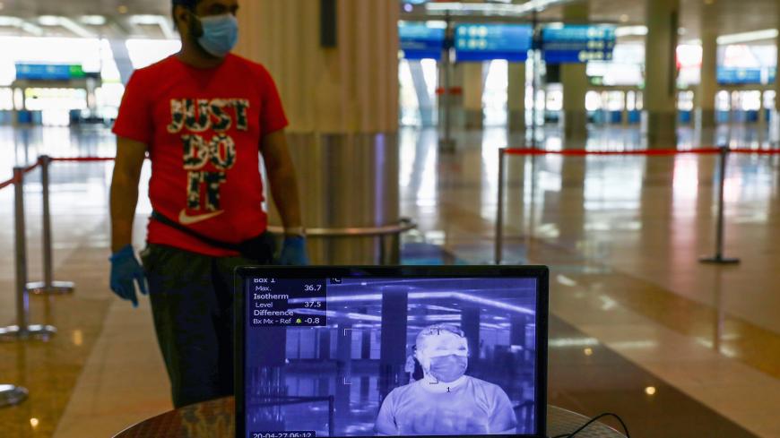 A man is seen through a thermal camera at Dubai International Airport, as Emirates airline resumed limited outbound passenger flights amid the outbreak of the coronavirus disease (COVID-19) in Dubai, UAE April 27, 2020. REUTERS/Ahmed Jadallah - RC2WCG97HRKE