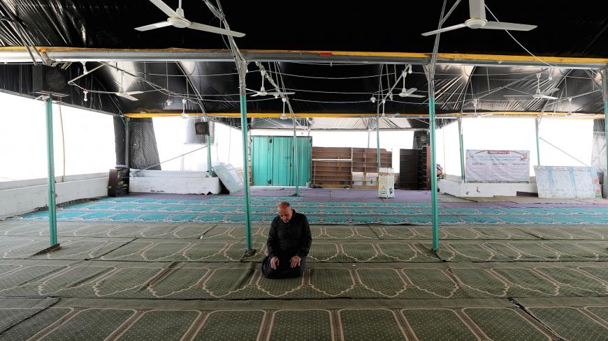 A Palestinian man prays inside a mosque on the second Friday of Ramadan as prayers are suspended due to concerns about the spread of the coronavirus disease (COVID-19) in Gaza City May 1, 2020. REUTERS/Mohammed Salem     TPX IMAGES OF THE DAY - RC2MFG9HFHIU