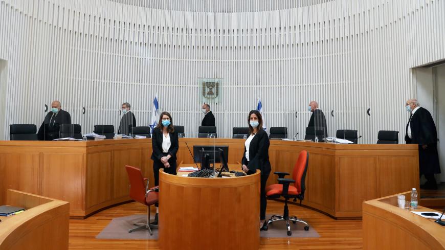 A panel of judges of the Israeli Supreme Court wear face masks as they address a discussion on a petition asking whether Israeli Prime Minister Benjamin Netanyahu can form a government legally and publicly when indictments are filed against him on a charges of fraud, bribery, and breach of trust, at the Israeli Supreme Court in Jerusalem May 4, 2020. Abir Sultan/Pool via REUTERS - RC2OHG9WN0SQ