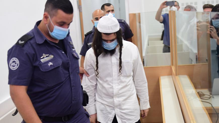 Amiram Ben-Uliel is brought for a verdict in the case of the 2015 arson attack, which killed a Palestinian toddler and his parents in the Israeli-occupied West Bank village of Duma, at the Central Lod District Court in Lod, Israel May 18, 2020. Avshalom Sassoni/Pool via REUTERS - RC2VQG99KFXQ