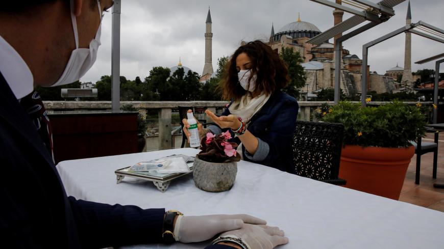 Four Seasons Sultanahmet Hotel staff members practice the service rules as they check the readiness of the hotel to the Healthy Tourism Certificate Program aims to convince travellers despite the spread of the coronavirus disease (COVID-19), in Istanbul, Turkey, May 21, 2020. Picture taken May 21, 2020. REUTERS/Umit Bektas - RC2QTG93W1FZ