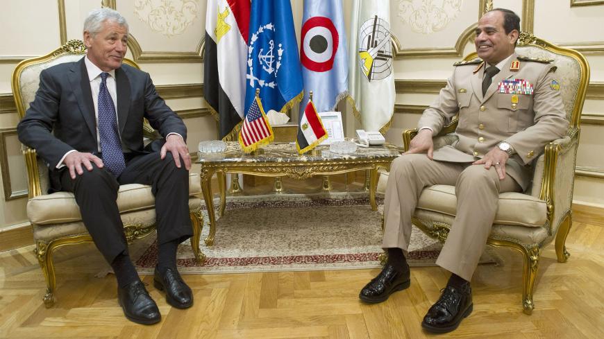 U.S. Defense Secretary Chuck Hagel (L) sits next to Egyptian Defence Minister General Abdel Fattah Sisi during a meeting at the Ministry of Defence in Cairo April 24, 2013.   REUTERS/Jim Watson/Pool   (EGYPT - Tags: POLITICS MILITARY) - GM1E94O1K1601