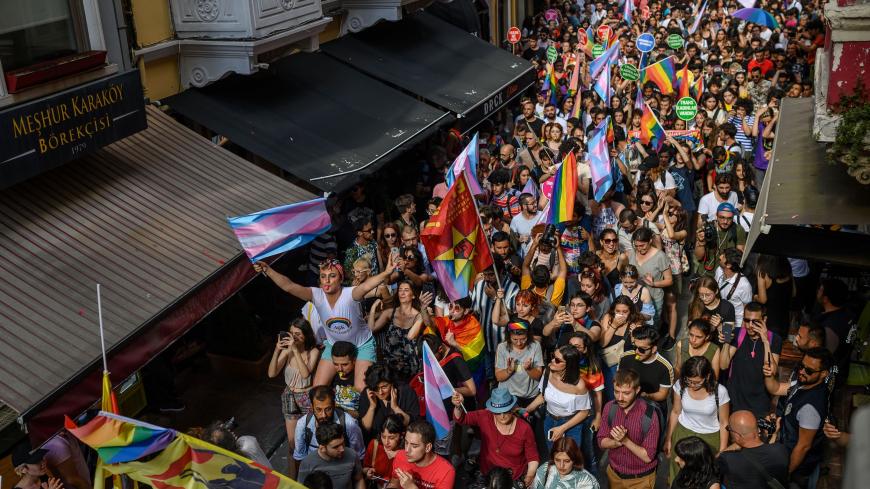 Members of the LGBTQ+ community wave flags as they participate in a march during the Gay Pride parade in Istanbul, on June 30, 2019. - Turkish police on June 30 fired tear gas at gay rights groups and activists who defied authorities to march for the Istanbul pride parade, banned for the fifth year in a row. Thousands of people rallied close to the popular Istiklal Avenue and Taksim Square where organisers originally planned to hold the parade, an AFP correspondent said. (Photo by BULENT KILIC / AFP)       