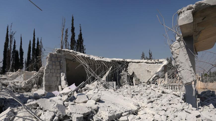 The ruins of buildings are pictured on July 1, 2019 at the site where the US military  carried out a strike against Al-Qaeda-linked jihadists in Syria's northwestern Aleppo province. - The US military said today it had targeted jihadists in an embattled northwestern opposition bastion in northwest Syria the previous day. The Syrian Observatory for Human Rights said the raid in Aleppo province killed six commanders and other jihadists from the Hurras al-Deen group. (Photo by Omar HAJ KADOUR / AFP)        (Ph