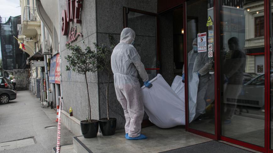 TOPSHOT - Forensic investigators carry the body of Iranian judge Gholamreza Mansour who died after a falling from high in a hotel atrium in Bucharest June 19, 2020. - "An investigation is underway," a police spokesman told AFP, confirming that the deceased was the Iranian judge Gholamreza Mansouri. (Photo by OCTAV GANEA / AFP) (Photo by OCTAV GANEA/AFP via Getty Images)
