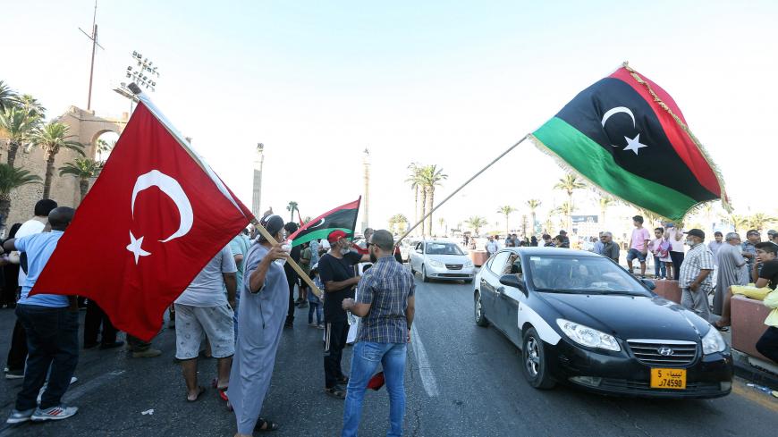 People wave flags of Libya (R) and Turkey (L) during a demonstration in the Martyrs' Square in the centre of the Libyan capital Tripoli, currently held by the UN-recognised Government of National Accord (GNA), on June 21, 2020. - The GNA on June 21 denounced Egypt's warning of military intervention in Libya, labelling it a "declaration of war", after the Egyptian President warned that if pro-GNA forces advanced on the strategic city of Sirte -- some 450 kilometres (280 miles) east of Tripoli -- it could pro
