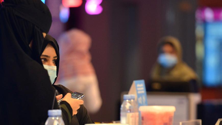 Saudi women buy tickets for a movie at a cinema in the capital Riyadh, on June 22, 2020 as cinemas re-opened following the lifting of a lockdown due to the COVID-19 coronavirus pandemic. (Photo by FAYEZ NURELDINE / AFP) (Photo by FAYEZ NURELDINE/AFP via Getty Images)
