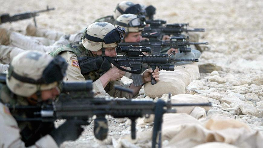 RAMADI, IRAQ:  US soldiers take part in a shooting training in the restive city of Ramadi, 100 kms west of Baghdad, 02 December 2004. The United States announced plans to increase its forces in Iraq to their highest levels since last year's invasion, as the country's interim government engaged in a flurry of contacts to rally support for January 30 elections.    AFP PHOTO/AHMAD AL-RUBAYE  (Photo credit should read AHMAD AL-RUBAYE/AFP via Getty Images)