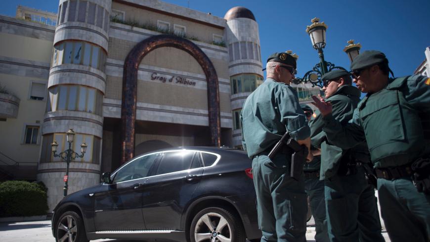 Members of the Spanish Guardia civil stand during a raid targeting assets of the family of Syrian leader Bashar al-Assad in the Puerto Banus marina area of the plush resort of Marbella on April 4, 2017.
The raids, a result of corruption investigation launched in France against Assad's uncle, Rifaat al-Assad, have seen the assets of Rifaat al-Assad and his family in Spain valued at 691 million euros ($736 million), seized.

 / AFP PHOTO / JORGE GUERRERO        (Photo credit should read JORGE GUERRERO/AFP via