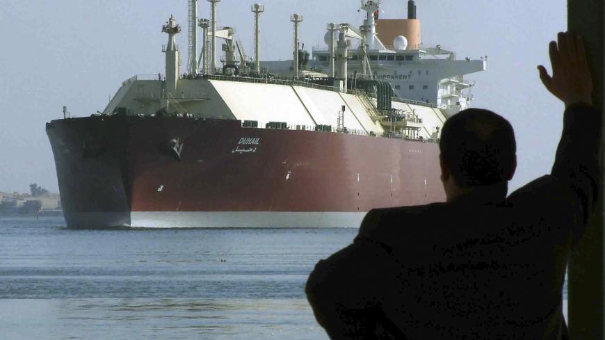 A man looks as the world's biggest Liquefied Natural Gas (LNG) tanker DUHAIL as she crosses through the Suez Canal April 1, 2008. The Qatari tanker, which was built to transfer LNG from Qatar to Europe and the U.S., is on her first trip ever from Qatar to Spain.    REUTERS/Stringer   (EGYPT) - GM1E44200C701