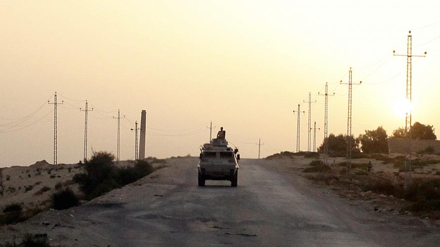FILE PHOTO: An Egyptian military vehicle is seen on the highway in northern Sinai, Egypt, May 25, 2015.   To match Special Report EGYPT-POLITICS/SINAI      REUTERS/Asmaa Waguih/File Photo - RC17BB4CC790