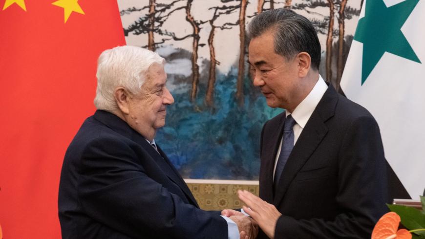 Syrian Foreign Minister Walid Muallem (L) shakes hands of Chinese Foreign Minister Wang Yi (R)  after a press conference at Diaoyutai state guesthouse in Beijing on June 18, 2019. Fred Dufour/Pool via REUTERS - RC1583F62660