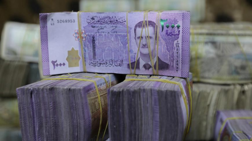 Syrian pounds are pictured inside an exchange currency shop in Azaz, Syria February 3, 2020. Picture taken February 3, 2020. REUTERS/Khalil Ashawi - RC2N3F9FNKPU