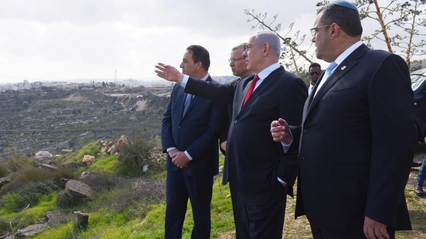 Israeli Prime Minister Benjamin Netanyahu points to the area of Israeli settlement of Har Homa, located in an area of the Israeli-occupied West Bank, that Israel annexed to Jerusalem after the region's capture in the 1967 Middle East war, February 20, 2020. Debbie Hill/Pool via REUTERS - RC2E4F97DQ5S