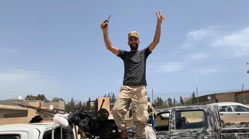 A fighter loyal to Libya's internationally recognised government celebrates after regaining control over the city, in Tripoli, Libya, June 4, 2020. REUTERS/Ayman Al-Sahili - RC2F2H9Z862R