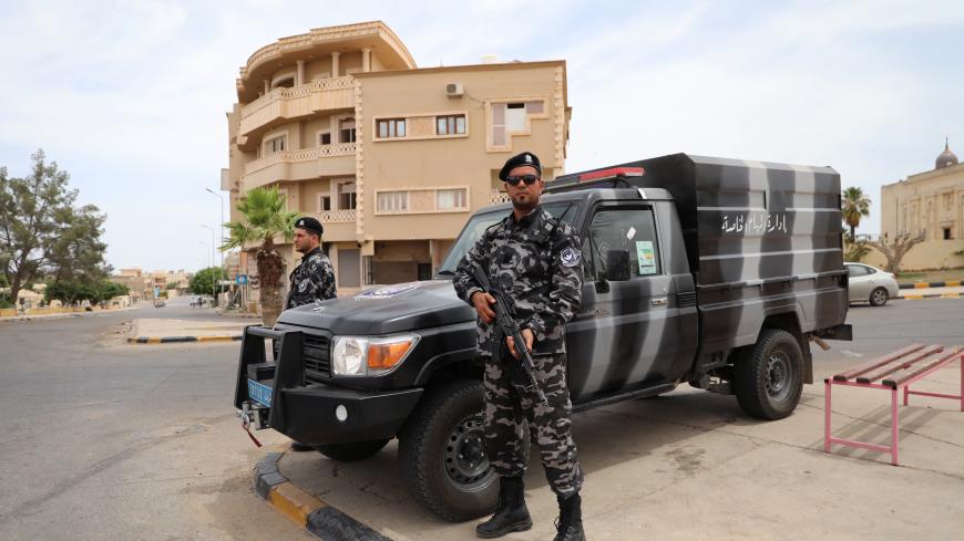A member of security forces loyal to Libya's internationally recognised government holds his weapon during a security deployment in Tarhouna city, Libya June 11, 2020. REUTERS/Ismail Zitouny - RC247H9IT468