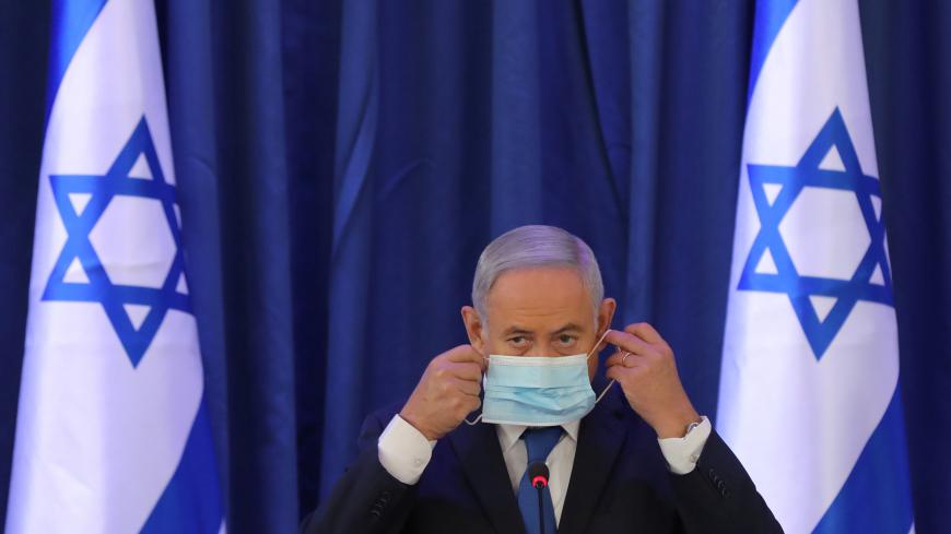 Israeli Prime Minister Benjamin Netanyahu, wearing a face mask, attends a government Cabinet meeting at the Ministry of Foreign Affairs, as the coronavirus disease (COVID-19) outbreak continues, in Jerusalem, June 21, 2020. Abir Sultan/Pool via REUTERS - RC2LDH94S2ER